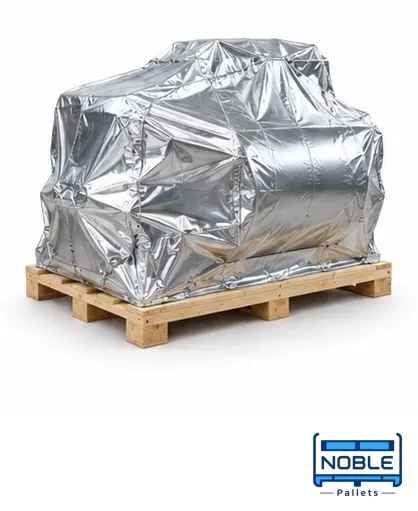 Barrier-Wrapped Machinery Industrial equipment enclosed in a silver barrier wrap on a timber base. Noble Pallets & Packaging, Pakistan.